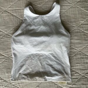 White Fabletics Workout Top with built in shelf bra and criss-cross strappy back